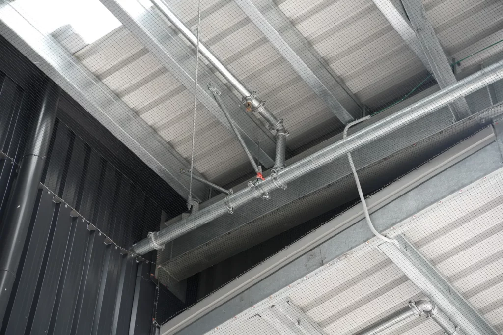 Bird netting protecting the upper interior of a commercial warehouse
